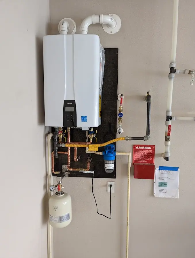 Professional plumber installing copper piping in a Haysville home